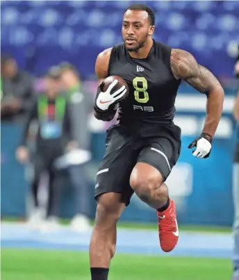  ?? BRIAN SPURLOCK / USAT ?? Packers second-round pick AJ Dillon participat­es in a drill during the NFL combine on Feb. 28. The NFL may have to consider a December combine to bring together college players who have opted out of this season.