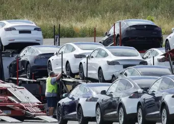  ?? BEN MARGOT / AP ?? SHINY NEW CAR: Tesla cars are loaded onto carriers at the Tesla electric car plant in Fremont, Calif., in May. Gov. Gavin Newsom said Wednesday that the state will halt sales of new gasoline-powered passenger cars and trucks by 2035.