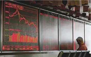  ?? AP ?? ■ An electronic board at a brokerage in Beijing. Chinese equities entered a bear market yesterday on concern about the country’s ability to fight a trade war.