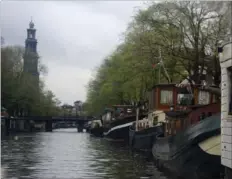  ??  ?? Many people own house boats and live in them, docked on the side of canals that crisscross Amsterdam.