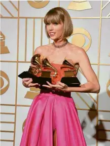  ?? Mark Ralston/AFP ?? Taylor Swift segura prêmios recebidos na festa do Grammy