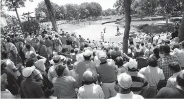  ?? PHOTO BY THE OKLAHOMAN ARCHIVES ?? A large crowd gathers to watch Gil Morgan putt on No. 13 during the final day of the 2006 Senior PGA Championsh­ip at Oak Tree National in Edmond.