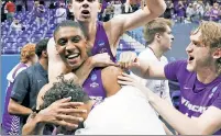  ?? Getty Images ?? HERO OF THE DAY: Joe Pleasant is surrounded by teammates after hitting the game-winning free throws to knock off heavily favored Texas on Saturday.