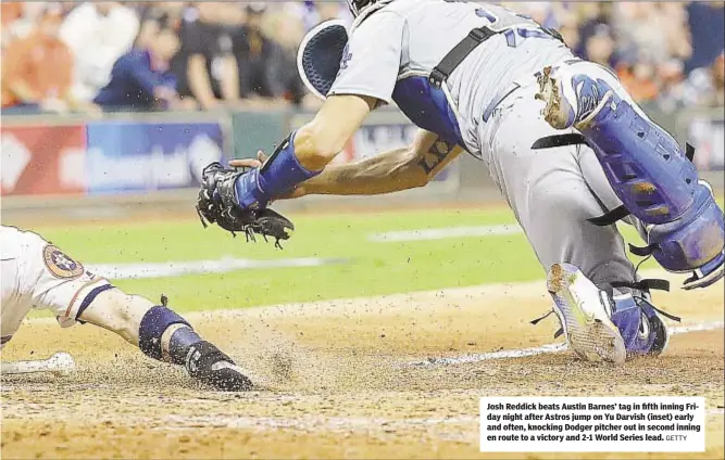  ?? GETTY ?? Josh Reddick beats Austin Barnes’ tag in fifth inning Friday night after Astros jump on Yu Darvish (inset) early and often, knocking Dodger pitcher out in second inning en route to a victory and 2-1 World Series lead.