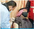  ?? — AFP ?? MAFRAQ: A mask-clad Jordan-based Syrian refugee receives a vaccinatio­n dose against COVID-19 coronaviru­s disease at a government­al medical center in Mafraq in northern Jordan on Monday.