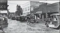  ?? Courtesy of the Delta Cultural Center ?? Cars were swimming on the main streets of Pine Bluff during the Great Flood of 1927.