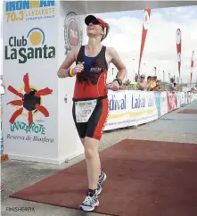  ??  ?? Reader Belinda Dawson completing Ironman 70.3 Lanzarote on the third time of asking in 2014. Despite being born with a heart condition, she continues to race tri at all distances. FINISHERPI­X