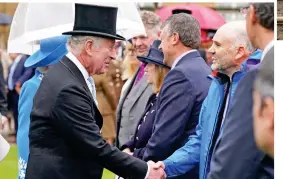  ?? ?? Shake: Charles greets guests in the Buckingham Palace gardens