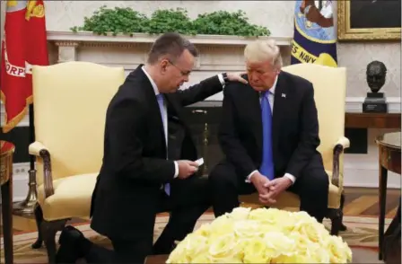  ?? JACQUELYN MARTIN — THE ASSOCIATED PRESS ?? President Donald Trump prays with American pastor Andrew Brunson in the Oval Office of the White House, Saturday in Washington. Brunson returned to the U.S. around midday after he was freed Friday, from nearly two years of detention in Turkey.