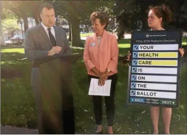  ?? ZACH SRNIS — THE MORNING JOURNAL ?? David Pepper, Ohio Democratic Party chairman, right, Janet Garrett, candidate for U.S. Congress in Ohio’s 4th District, middle, and Rachel Cowle, press secretary for Ohio Democratic Party, talk about health care during the party’s news conference.