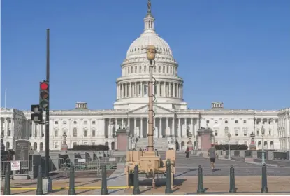  ?? J. SCOTT APPLEWHITE/AP ?? A video surveillan­ce apparatus is seen on the East Front of the Capitol in Washington on Friday.