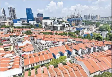  ?? ROSLAN RAHMAN/AFP ?? Singaporea­n developers sold 1,178 private homes last month, up 43.5 per cent from the 821 units they moved in June.