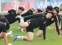  ?? AP ?? South Korea’s Son Heung-min limbering up along with his teammates during training session.