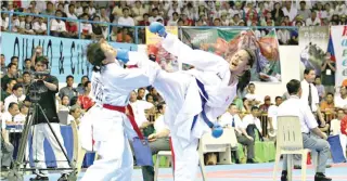  ??  ?? Karateka Gretchen Malalad throws a mawashi geri against a foe during competitio­n.