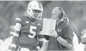  ?? JOEL AUERBACH/GETTY IMAGES ?? Though he hasn’t been officially named the No. 2 QB, redshirt freshman N’Kosi Perry, left, is generally regarded as such.