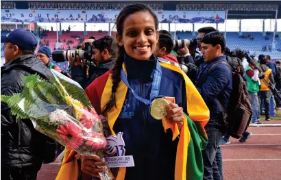  ??  ?? The US-based marathoner Hiruni Wijayaratn­e after winning Sri Lanka's first South Asian Games gold medal in Kathmandu, Nepal in 2019.