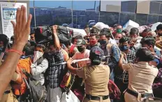  ?? Reuters ?? Police officers attempt to control a crowd at a railway station amid the coronaviru­s pandemic in Mumbai, yesterday.