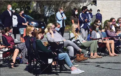  ?? Erik Trautmann / Hearst Connecticu­t Media ?? Local residents listen as members of the Wilton Clergy Associatio­n lead the community in prayers, readings, music and time for reflection for the three people who died recently at Wilton High School.