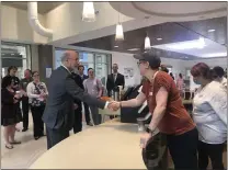  ?? RACHEL RAVINA — MEDIANEWS GROUP ?? Gov. Tom Wolf shakes hands with Keri Fisher, program director for the Common Grounds training program at Manna on Main Street, Wednesday morning during a visit to North Penn Commons in Lansdale.