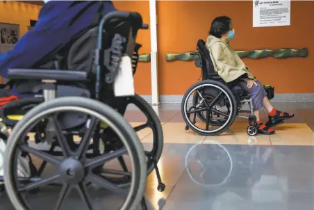  ?? Gabrielle Lurie / The Chronicle ?? Resident Bernadette Yee pushes herself through Laguna Honda, San Francisco’s largest skilled nursing facility.