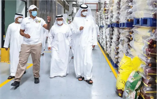  ?? ?? ↑ Dr Sultan Bin Ahmed Al Jaber is being briefed during his visit to the headquarte­rs of Al Dahra Group.