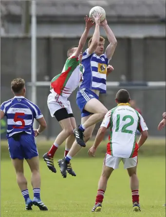  ??  ?? Blessingto­n’s David Boothman catches above Kiltegan’s Liam Keogh.