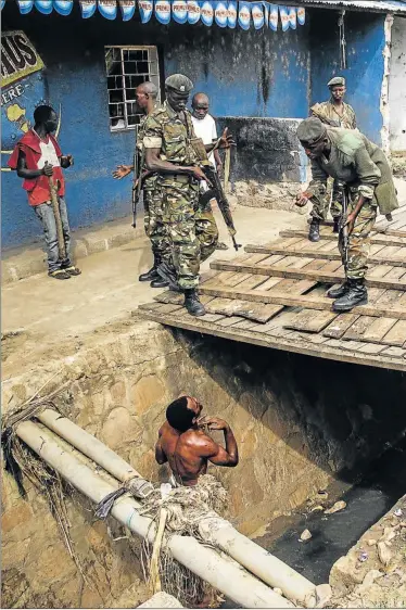  ?? Picture: AFP ?? CLOSE SHAVE: A man pleads with Burundian soldiers while trying to escape a lynching by a mob in Bujumbura on Thursday. The man was finally saved by the army