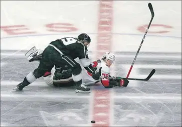  ?? Luis Sinco Los Angeles Times ?? THE PUCK IS GETTING away from them, but Kings left wing Alex Iafallo, on top, and Ottawa defenseman Thomas Chabot don’t seem all that worried about it during the second period at Staples Center.