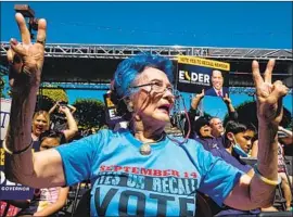  ?? Ringo Chiu AFP/Getty Images ?? SUPPORTERS OF recalling Gov. Gavin Newsom and electing Republican Larry Elder as his replacemen­t rally in Orange County’s Little Saigon this month.