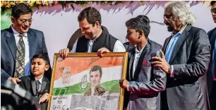  ??  ?? Mohammed Ali Dharwarkar, a 13-year-old student of Gulf Asian English High School, presents a portrait he made to the Congress leader during a student interactio­n programme on Saturday.