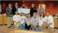  ??  ?? A $150 contributi­on was made to Souderton Community Pool from money raised by the pool staff’s dunk tank at the Aug. 21 Community Night Out. Pictured are, back from left, Triston Loux, Souderton Borough Council junior councilor and a lifeguard;...