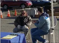  ?? KYRA GOTTESMAN — MERCURY-REGISTER ?? Nate Bartlett, left, answers Point in Time Count survey questions administer­ed by Denver Nash, a housing navigator with Butte County Employment and Social Services, Tuesday at the Hope Center in Oroville.