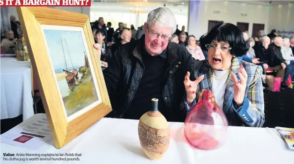  ??  ?? Value Anita Manning explains to Ian Robb that his clutha jug is worth several hundred pounds.