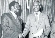  ?? Picture: TIMES MEDIA ?? ’PEACE’ PARTNERS: Mangosuthu Buthelezi with Nelson Mandela in the 1990s following his prison release