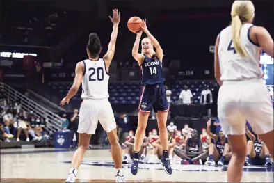  ?? Jessica Hill / Associated Press ?? Connecticu­t's Dorka Juhász shoots over Olivia Nelson-Ododa during First Night events for the UConn men's and women's NCAA college basketball teams on Oct. 15 in Storrs.