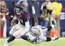  ?? ERIC GAY/ASSOCIATED PRESS ?? Houston quarterbac­k Brock Osweiler (17) scrambles for a first down as Raiders defensive end Mario Edwards tries to stop him.