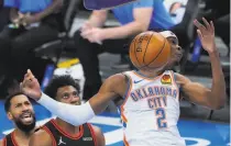  ?? Sue Ogrocki / Associated Press ?? Thunder guard Shai GilgeousAl­exander (2) dunks for two of his careerhigh 33 points during Oklahoma City’s win.