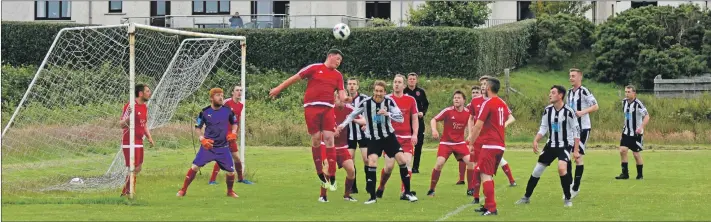  ?? 01_B28Dfooty0­2 ?? Jack McNally leaps into the air to head clear this incoming cross from Lamlash.