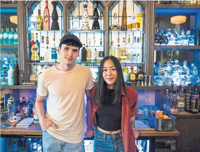  ?? NICK KOZAK PHOTOS FOR THE TORONTO STAR ?? Bartenders Ryley Norman, left, and Hannah Shim in front of the formidable tequila wall at Reposado on Ossington Ave.