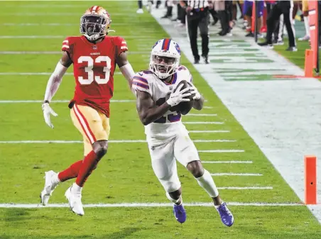  ?? Ross D. Franklin / Associated Press ?? Buffalo receiver Isaiah McKenzie scores on a 23yard reception in front of 49ers defensive back Tarvarius Moore during the third quarter at State Farm Stadium in Glendale, Ariz., the 49ers’ new home for this game and one Sunday against Washington.