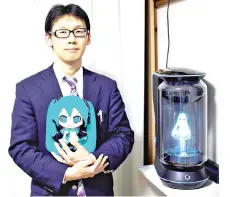  ??  ?? Akihiko Kondo poses next to a hologram of Hatsune Miku as he holds the doll version of her at his apartment in Tokyo, a week after marrying her. — AFP photo