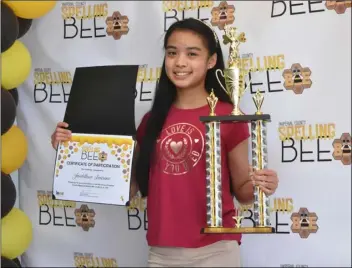  ?? PHOTO TOM BODUS ?? Imperial Valley Home School Academy seventh-grader Jaedilline Laurino shows off her first-place trophy Monday from the 16th annual Imperial County Regional Spelling Bee, held March 16.