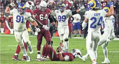  ?? ROB SCHUMACHER/THE REPUBLIC ?? Los Angeles Rams defensive end Greg Gaines (91) reacts after sacking Arizona Cardinals quarterbac­k Kyler Murray (1) in the fourth quarter Monday at State Farm Stadium in Glendale, Ariz.