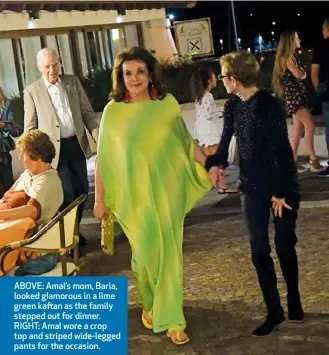  ??  ?? ABOVE: Amal’s mom, Baria, looked glamorous in a lime green kaftan as the family stepped out for dinner. RIGHT: Amal wore a crop top and striped wide-legged pants for the occasion.