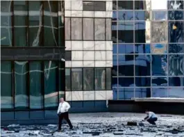  ?? ASSOCIATED PRESS ?? Investigat­ors examined an area next to a building damaged by a drone in the Moscow business district early Tuesday.