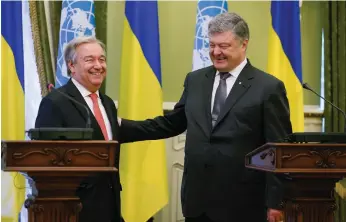  ?? Sergey Dolzhenko / EPA ?? Ukrainian president Petro Poroshenko, right, and United Nations secretary general Antonio Guterres share a light moment after their meeting in Kiev yesterday