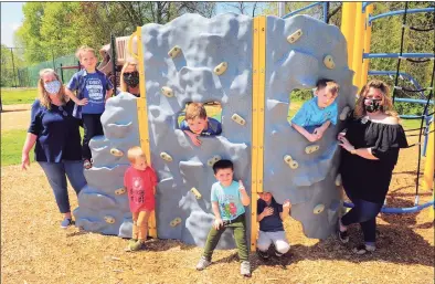  ?? Christian Abraham / Hearst Connecticu­t Media ?? Katie Sninsky, owner of The Hideout, at right, poses with the enrolled children and two teachers on staff at the business in Shelton on May 15, 2020. The preschool and childcare facility is still open, but only have about 6 kids on site during the pandemic, where before they usually had about 30 at any given time.