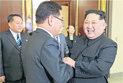  ??  ?? Kim Jong-un, far right, shakes hands with Chung Eui-yong, the leader of the South Korean delegation, during their unpreceden­ted meeting in Pyongyang, the North Korean capital