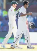  ??  ?? Australia’s captain Tim Paine congratula­tes not out Indian batsman Ravichandr­an Ashwin.