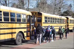  ?? Tyler Sizemore / Hearst Connecticu­t Media file photo ?? Students board a bus at North Mianus School in the Riverside section of Greenwich on March 2.